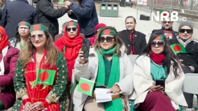 Group of people wearing green headbands with red dots, holding Bangladesh flags at an outdoor event, NRB HD watermark visible in top-right.