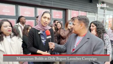 Female reporter interviews a woman wearing a hijab on a street, holding a red NRB microphone while a crowd watches; caption: 'Momentum Builds as Doly Begum Launches Campaign'