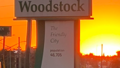 Woodstock welcome sign at sunset, reading 'Welcome to Woodstock' and 'The Friendly City', population 46,705.