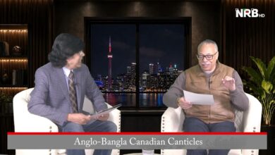 Two men in a TV studio interview sit on white chairs, reading papers, with a night city skyline backdrop and the NRB HD logo; banner reads Anglo-Bangla Canadian Canticles.
