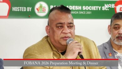 Man in a tan suit speaks into a microphone at a panel, with a green banner behind reading 'FOBANA 2026 Preparation Meeting & Dinner' and another man seated beside him.