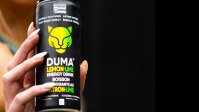 Person's hand holding a black can of DUMA Lemon-Lime energy drink with a bright green logo and lemon-lime flavor text visible