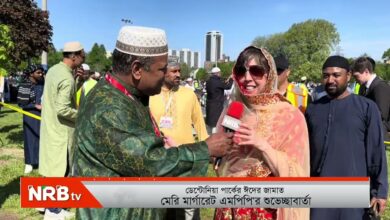 News reporter from NRB TV interviews a smiling woman in a patterned headscarf at an outdoor cultural event.