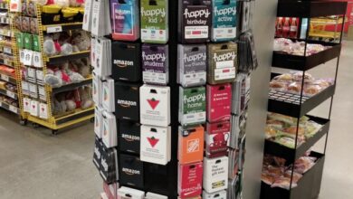 Circular display of gift cards on a tall, rotating stand in a store, labeled The Gift Center.